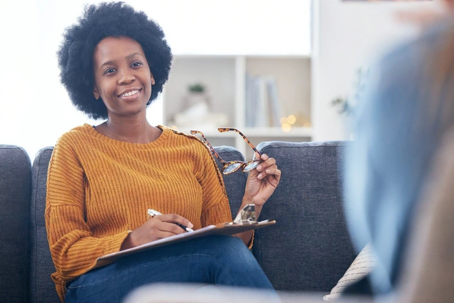 Mental health clinician speaking with a patient during a therapy consultation